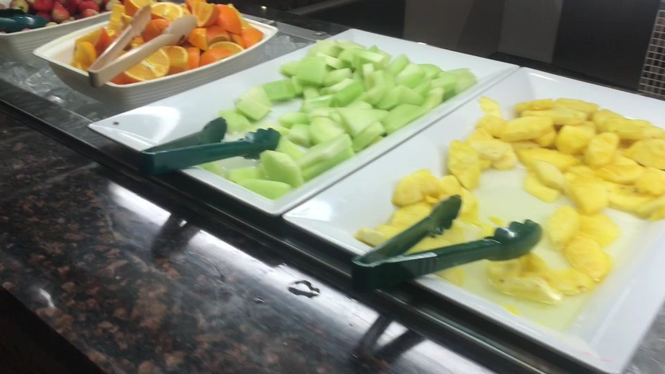 Colorful buffet spread with salad bar nearby.